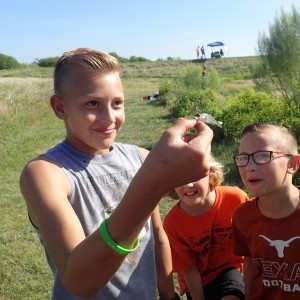 Kids holding a small fish